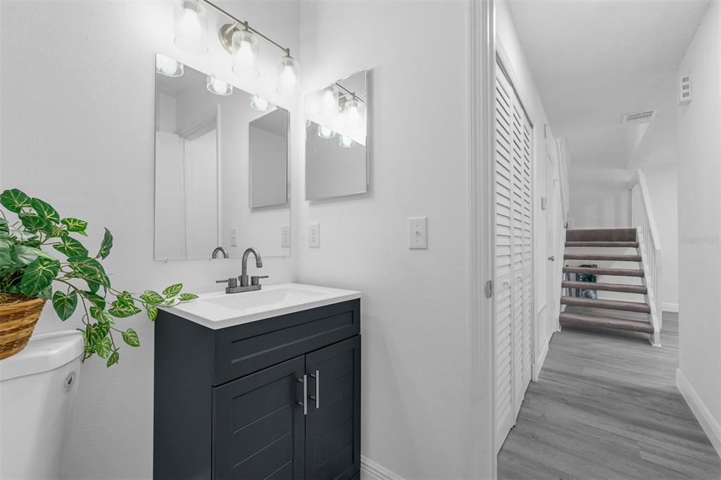 4402 Ring Neck Road, Unit 19B Orlando, FL 32808 - Photo 13 of 35 a bathroom with a sink and mirror