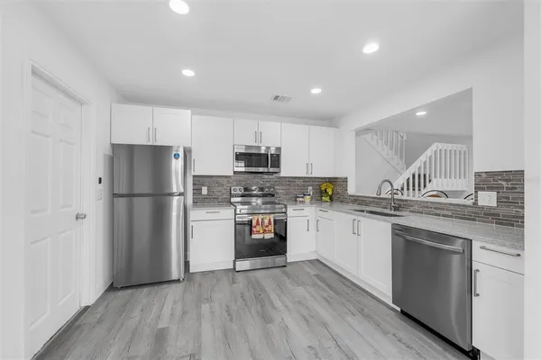 a kitchen with a sink and a stove