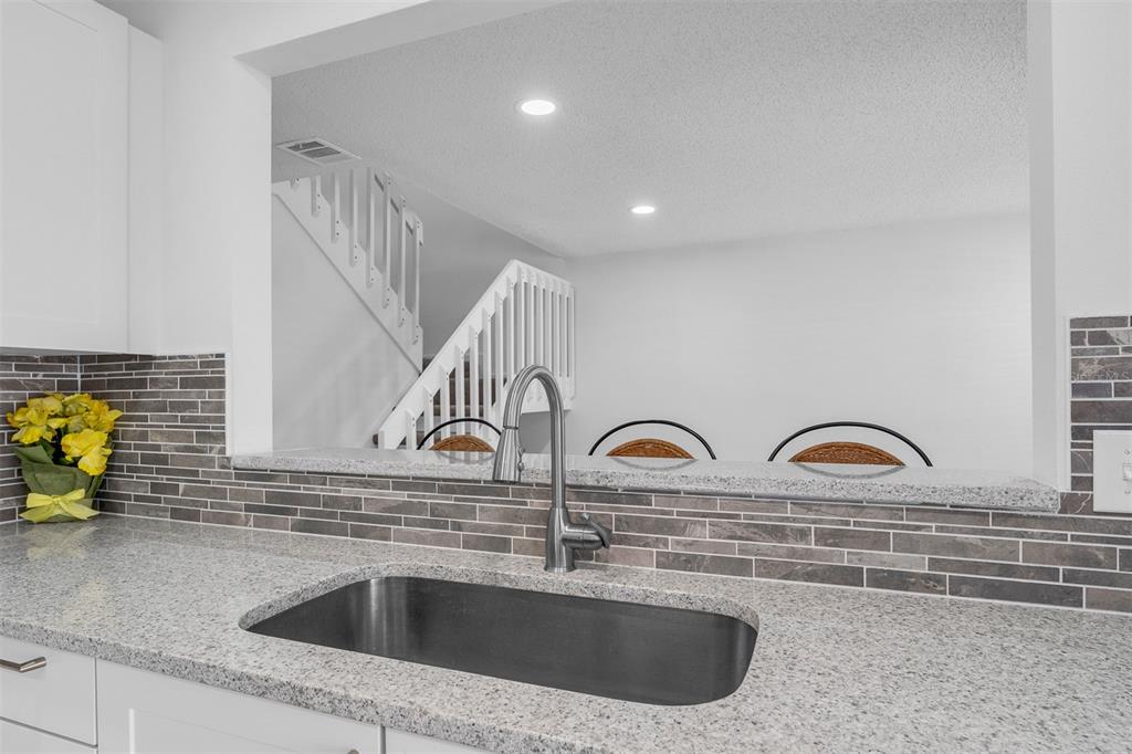 4402 Ring Neck Road, Unit 19B Orlando, FL 32808 - Photo 16 of 35 a kitchen with a sink and a stove