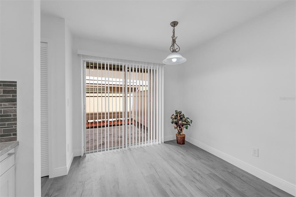 4402 Ring Neck Road, Unit 19B Orlando, FL 32808 - Photo 17 of 35 a view of a room with wooden floor