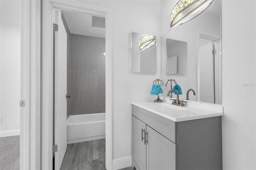 4402 Ring Neck Road, Unit 19B Orlando, FL 32808 - Photo 23 of 35 a bathroom with a sink a vanity and a mirror