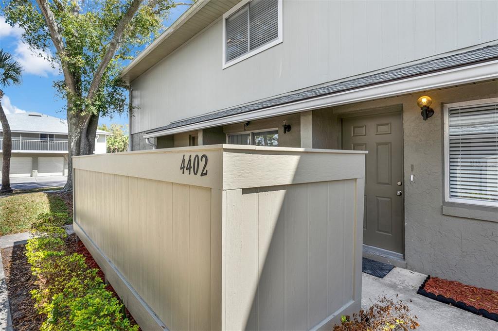 4402 Ring Neck Road, Unit 19B Orlando, FL 32808 - Photo 5 of 35 a front view of a house with garden