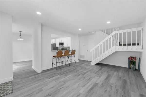 a view of a room with wooden floor and stairs