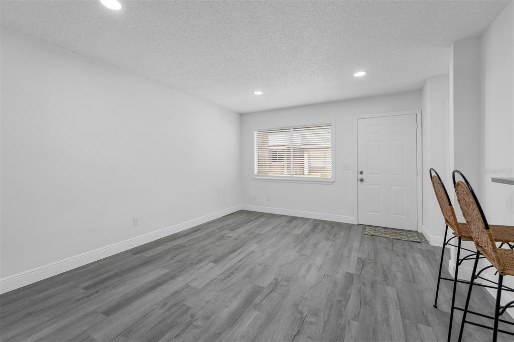 4402 Ring Neck Road, Unit 19B Orlando, FL 32808 - Photo 9 of 35 a view of room with wooden floor and windows