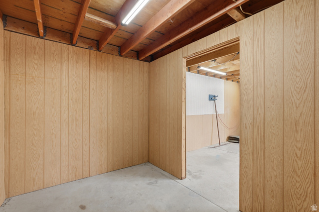 378 West 200 South Bountiful, UT 84010 - Photo 29 of 32 Wood-paneled room featuring exposed wood ceiling joists, concrete flooring, and fluorescent lighting
