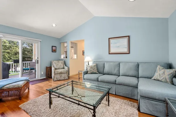 a living room with furniture a rug and a large window