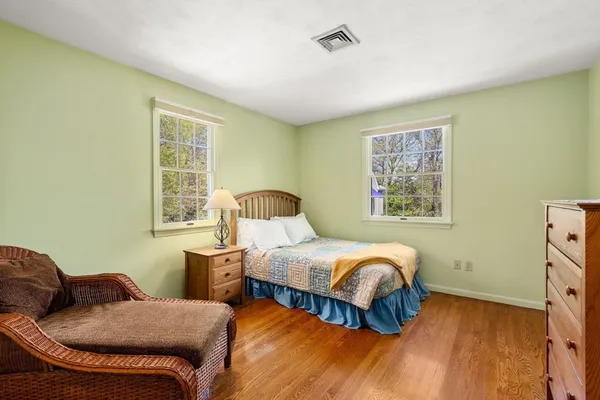 a bedroom with two beds and a window