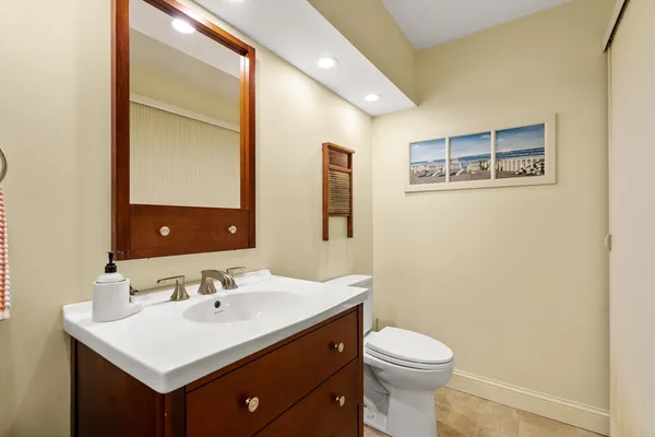 a bathroom with a sink mirror and toilet