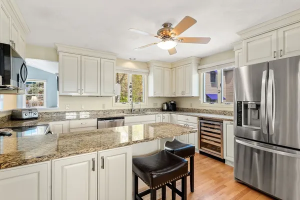 a kitchen with granite countertop a center island stainless steel appliances and cabinets