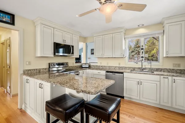 a kitchen with a stove a sink and a refrigerator