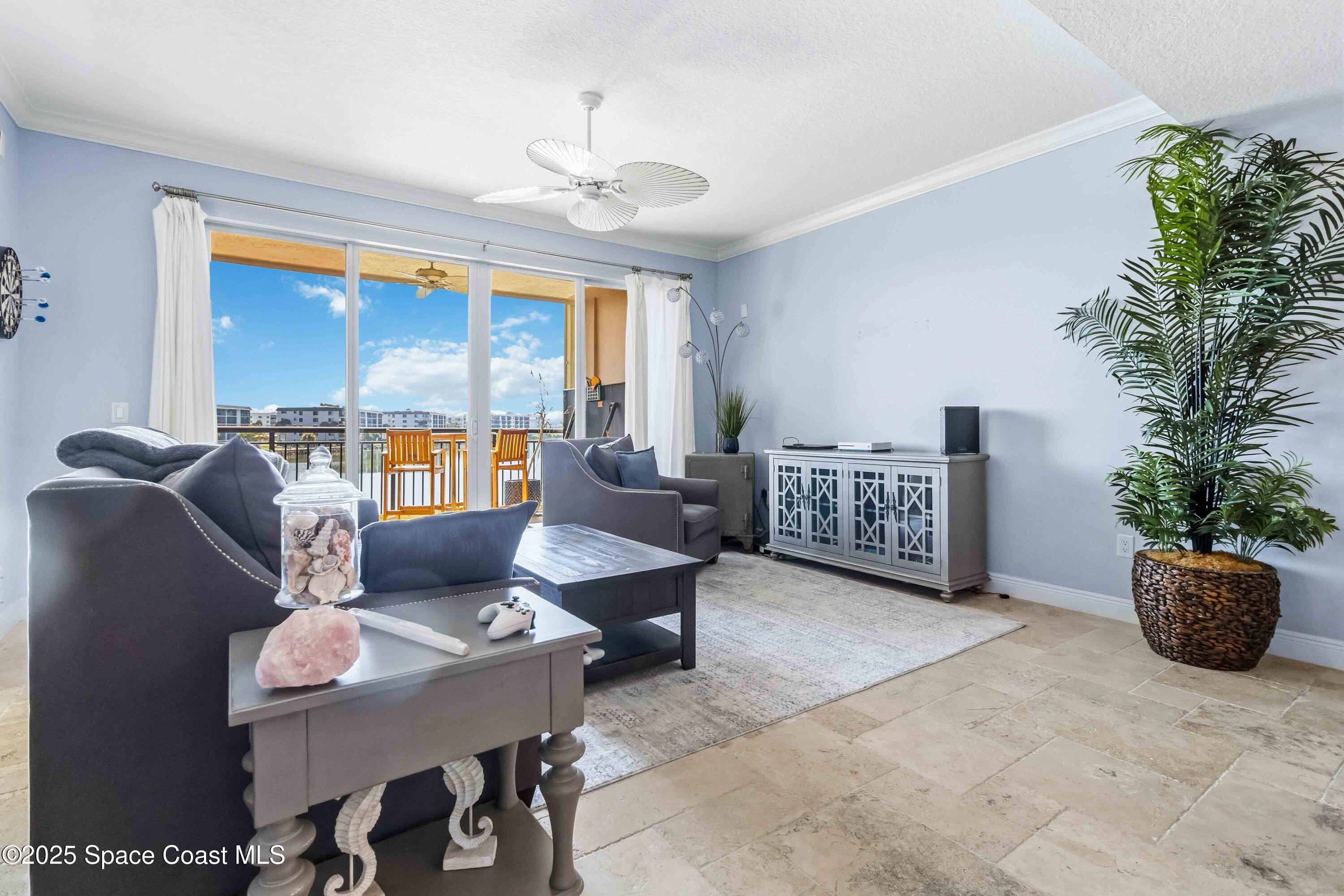 4125 West End Road, Unit 306 Cocoa Beach, FL 32931 - Photo 13 of 51 a living room with furniture and a potted plant
