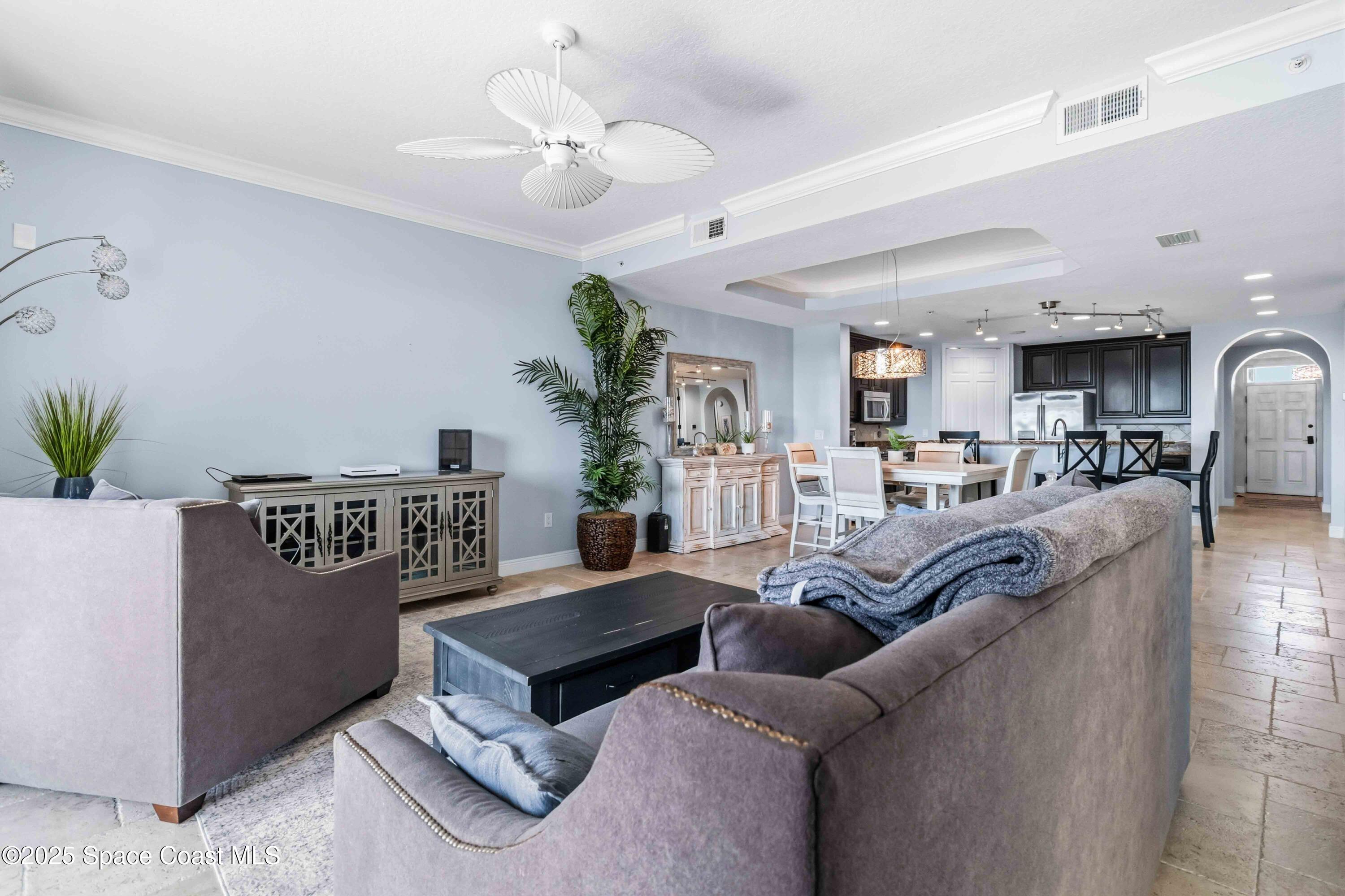 4125 West End Road, Unit 306 Cocoa Beach, FL 32931 - Photo 14 of 51 a living room with furniture kitchen view and a chandelier
