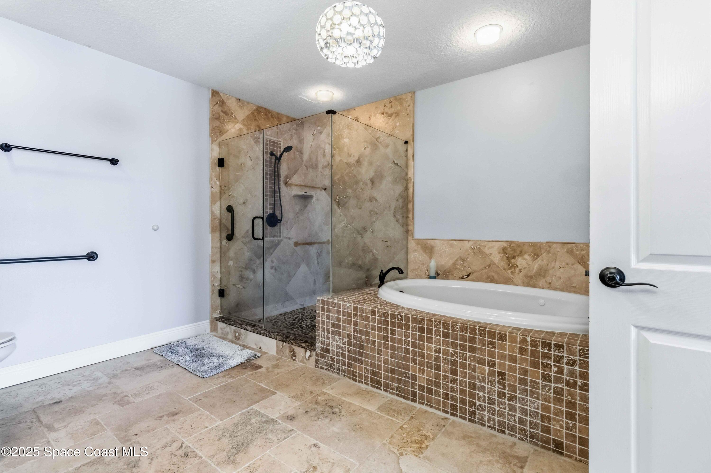 4125 West End Road, Unit 306 Cocoa Beach, FL 32931 - Photo 19 of 51 a bathroom with a sink a toilet and shower