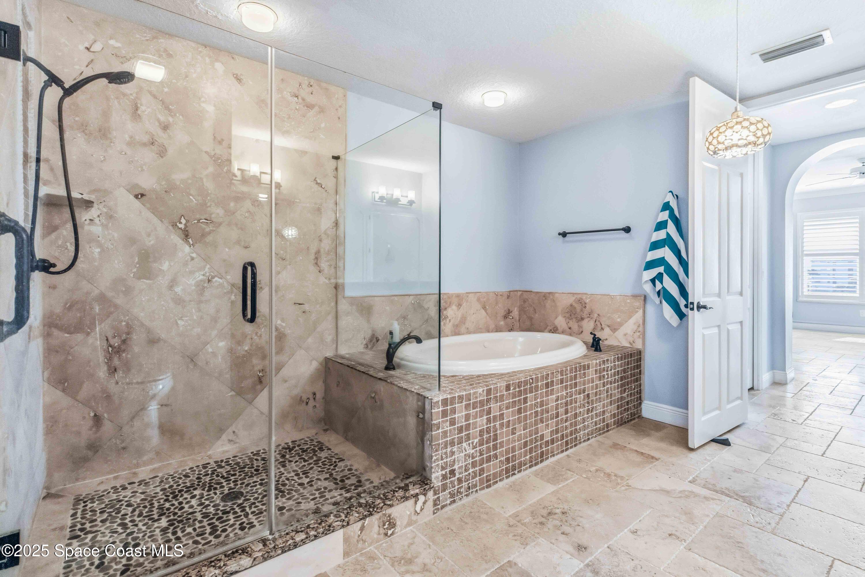 4125 West End Road, Unit 306 Cocoa Beach, FL 32931 - Photo 20 of 51 a bathroom with a bathtub and shower