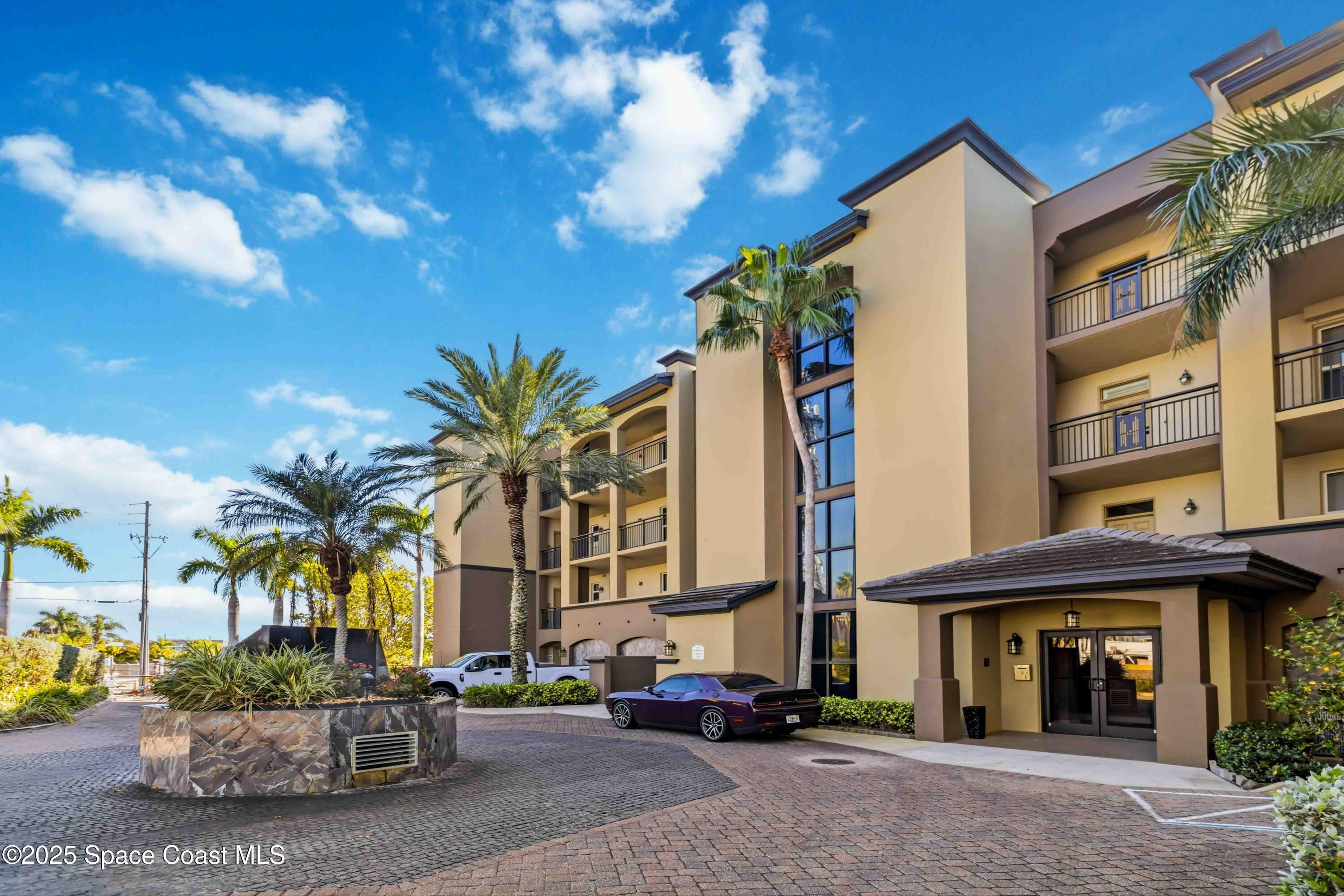 4125 West End Road, Unit 306 Cocoa Beach, FL 32931 - Photo 2 of 51 a view of a building with a pathway