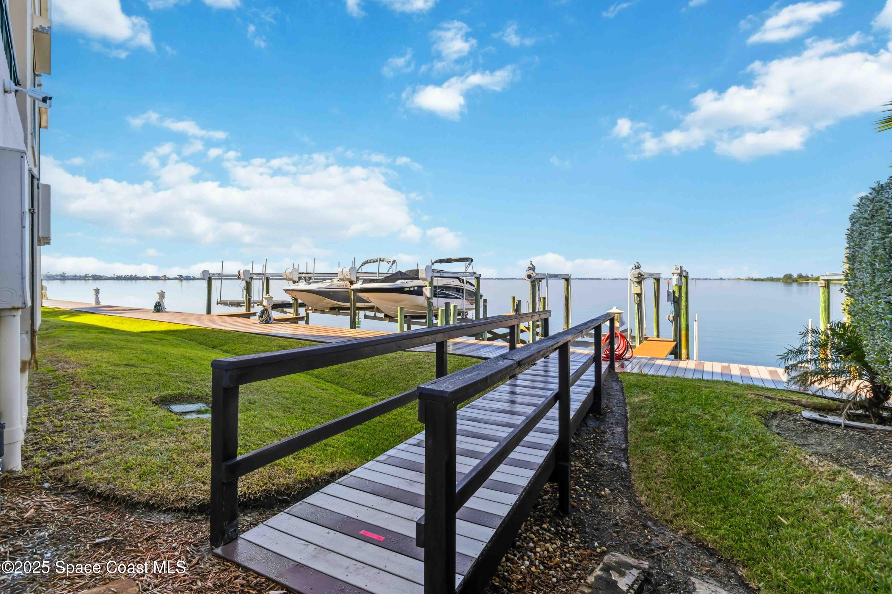 4125 West End Road, Unit 306 Cocoa Beach, FL 32931 - Photo 25 of 51 a view of a garden with houses