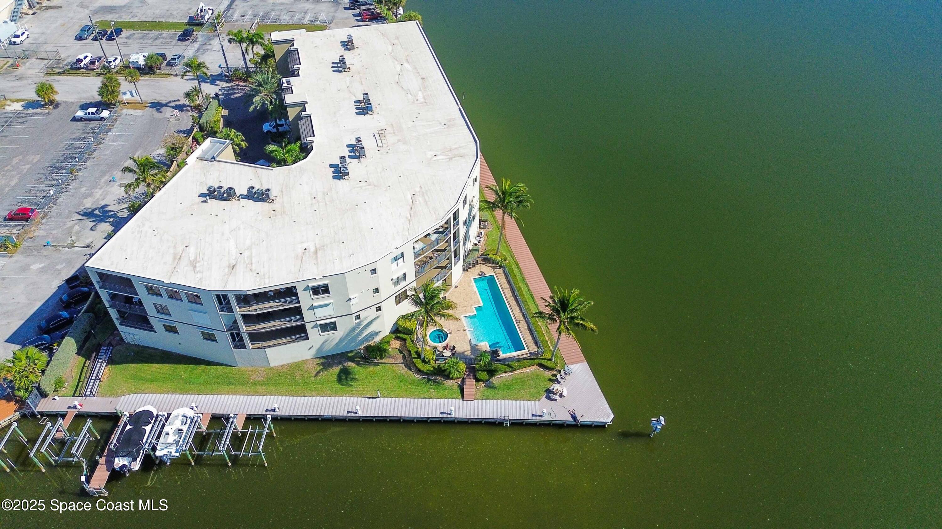 4125 West End Road, Unit 306 Cocoa Beach, FL 32931 - Photo 37 of 51 an aerial view of residential houses with outdoor space and swimming pool