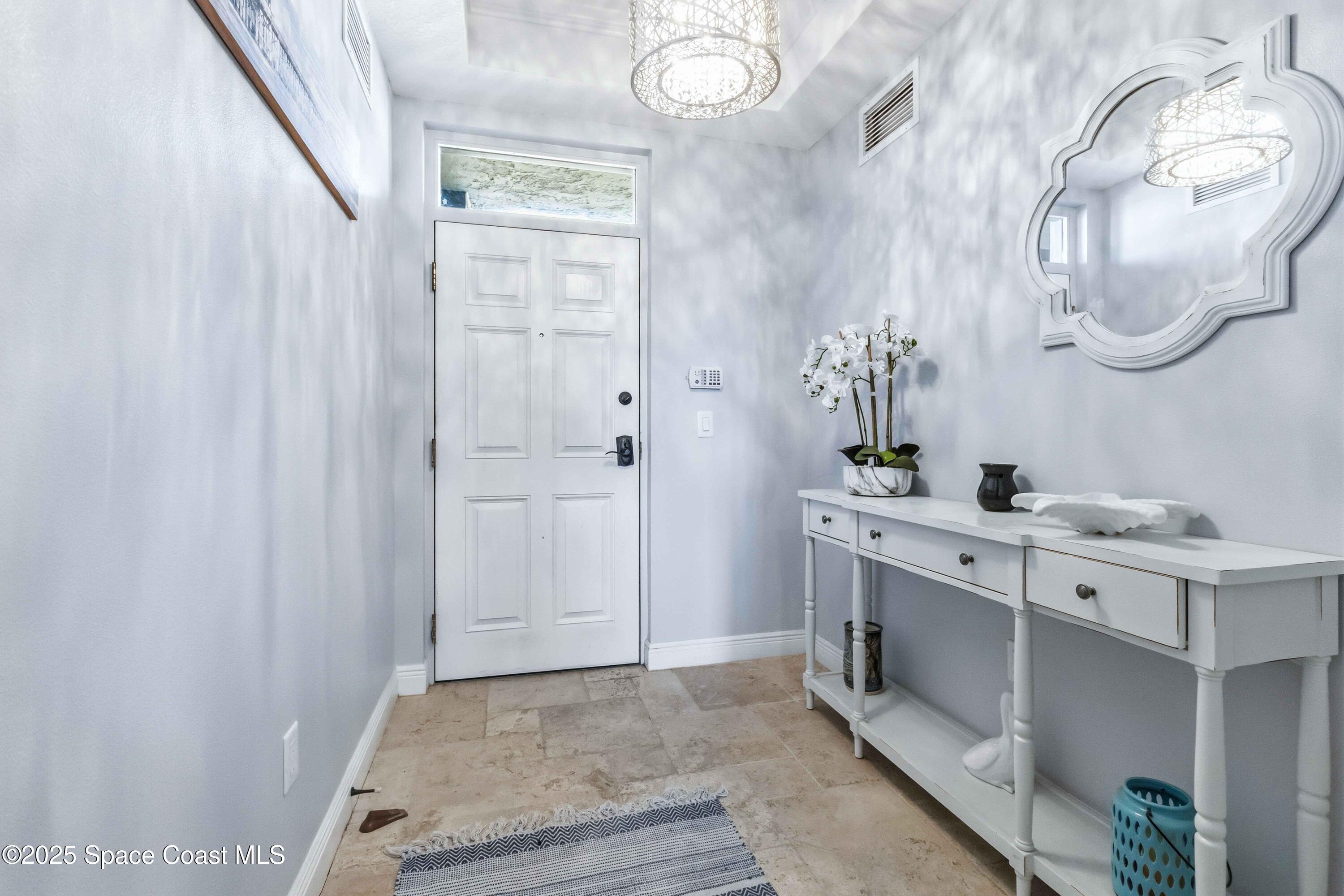 4125 West End Road, Unit 306 Cocoa Beach, FL 32931 - Photo 4 of 51 a spacious bathroom with a double vanity sink and a mirror