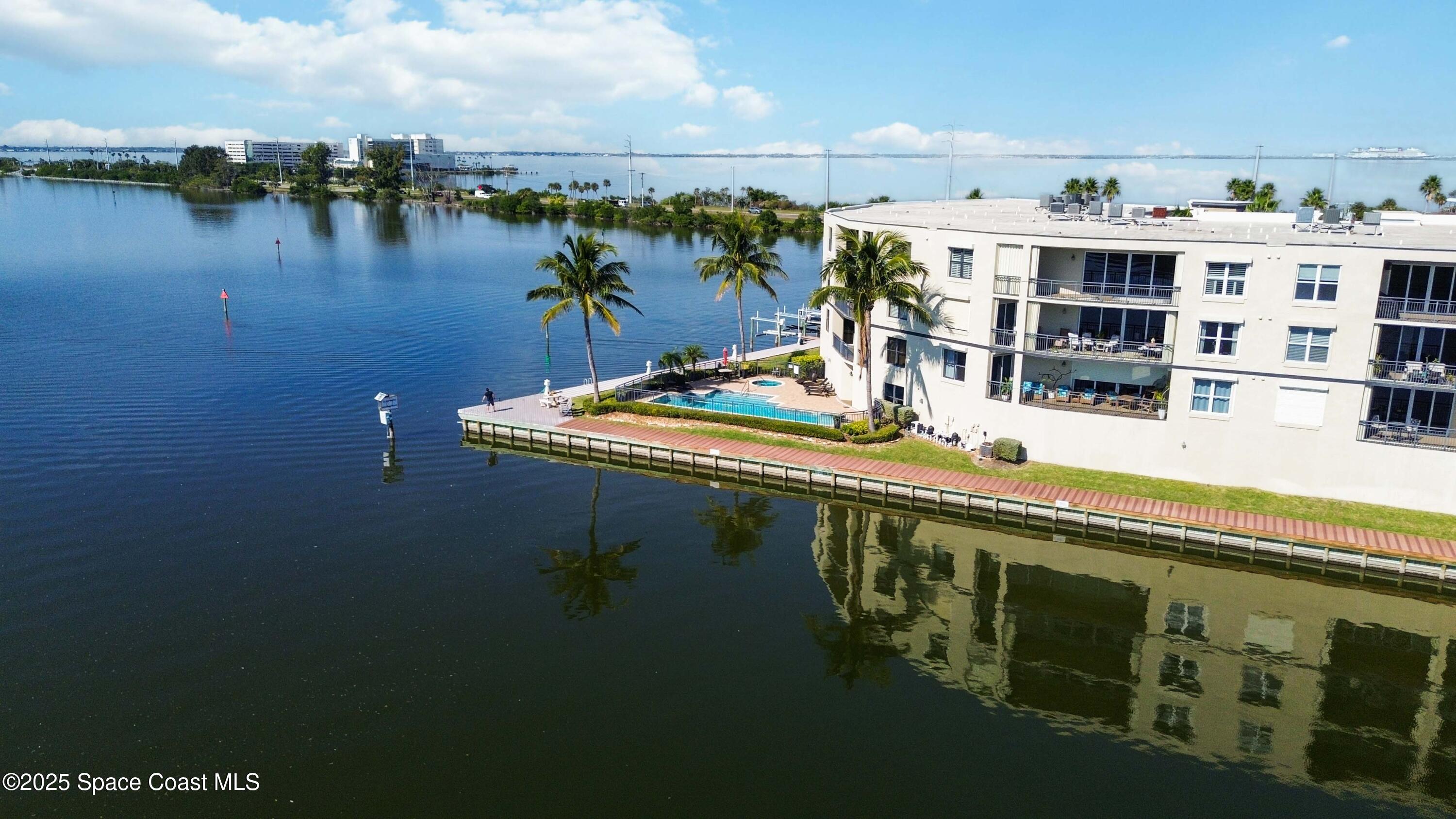 4125 West End Road, Unit 306 Cocoa Beach, FL 32931 - Photo 41 of 51 a terrace with a table and chairs