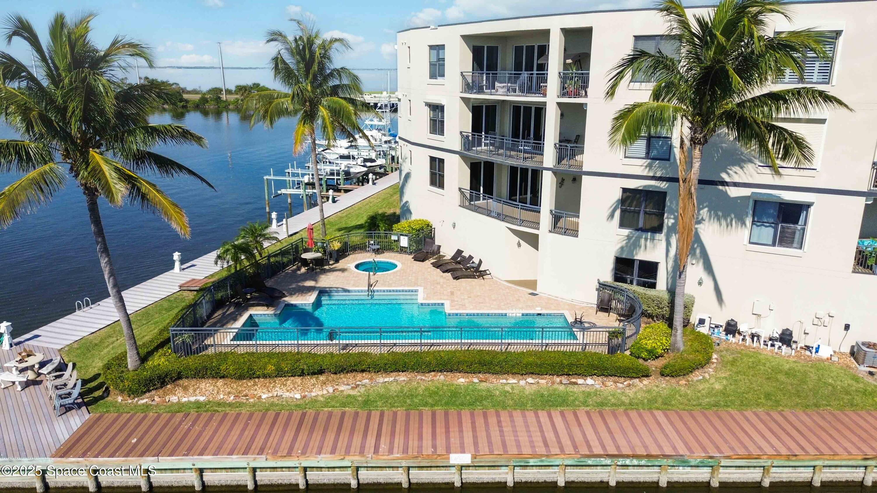 4125 West End Road, Unit 306 Cocoa Beach, FL 32931 - Photo 42 of 51 a front view of a house with a yard