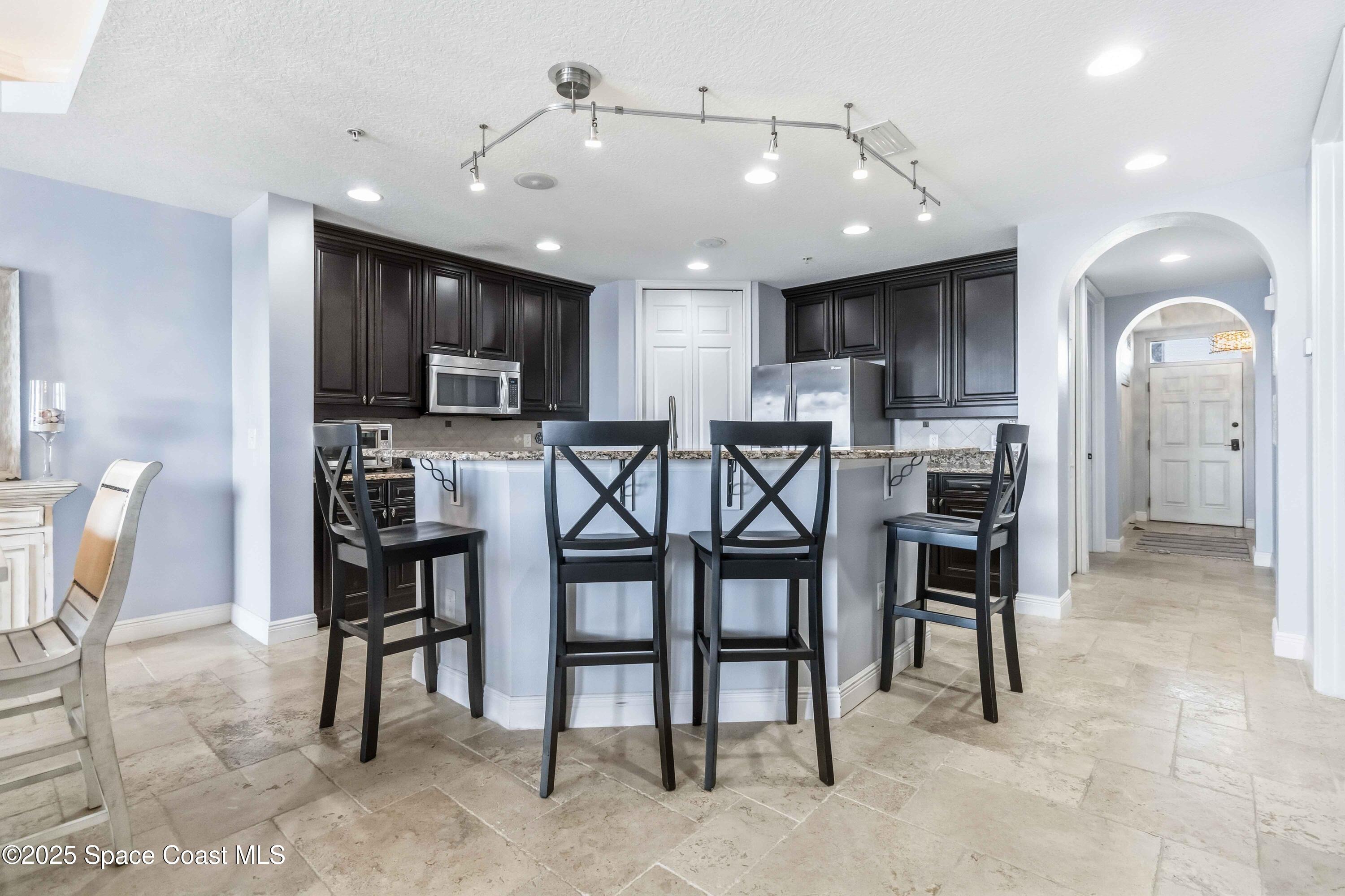 4125 West End Road, Unit 306 Cocoa Beach, FL 32931 - Photo 6 of 51 a view of a dining room with furniture