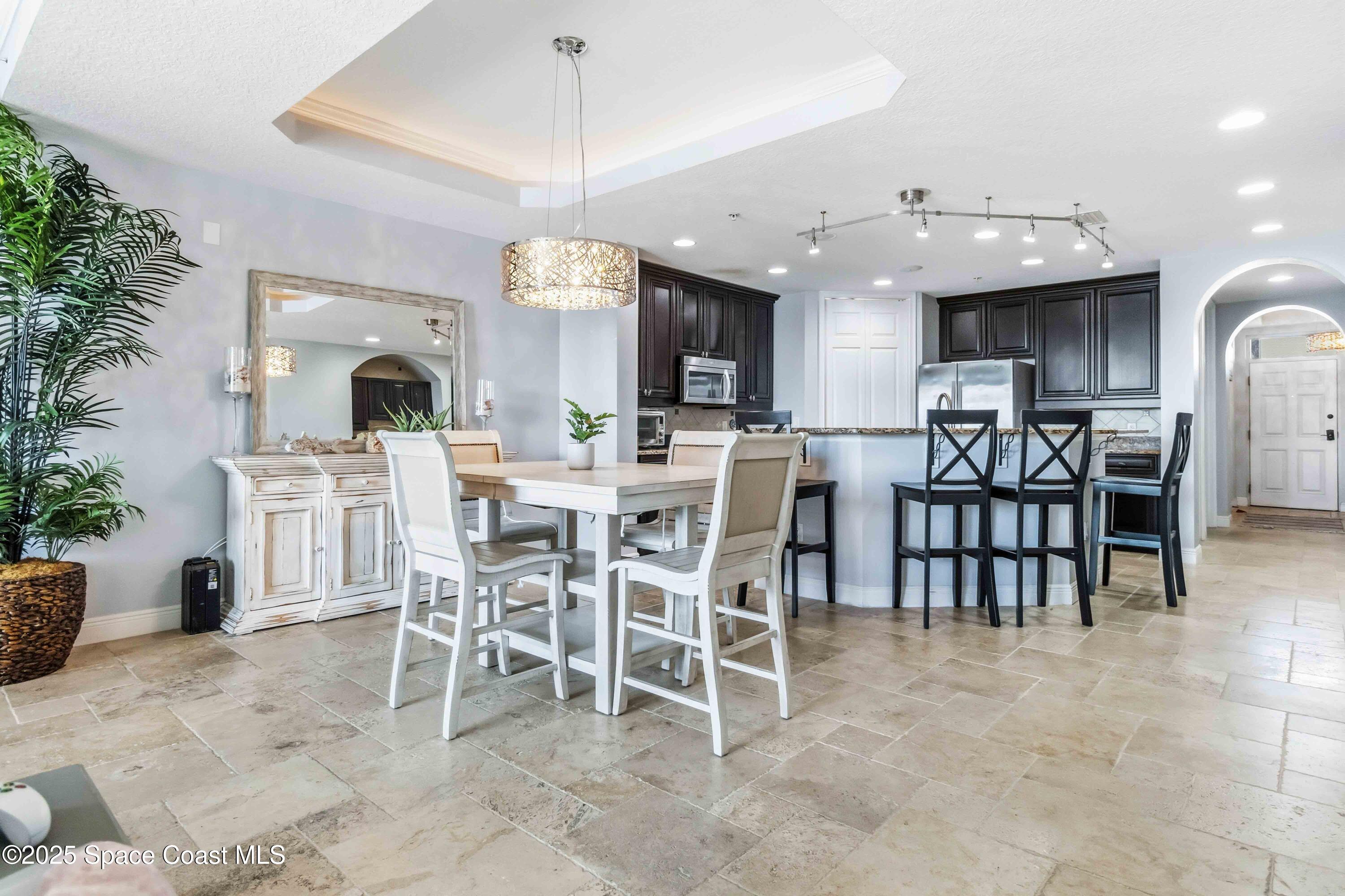 4125 West End Road, Unit 306 Cocoa Beach, FL 32931 - Photo 9 of 51 a view of a dining room with furniture