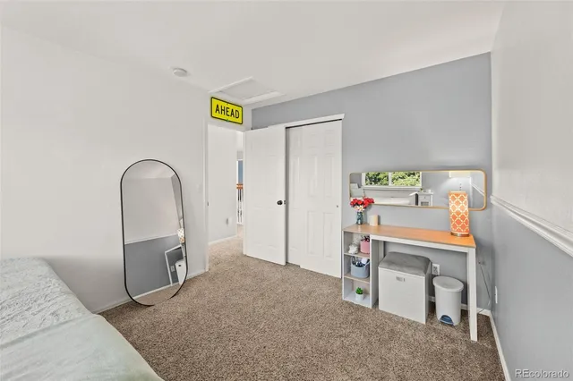 a spacious bedroom with a bed and a window