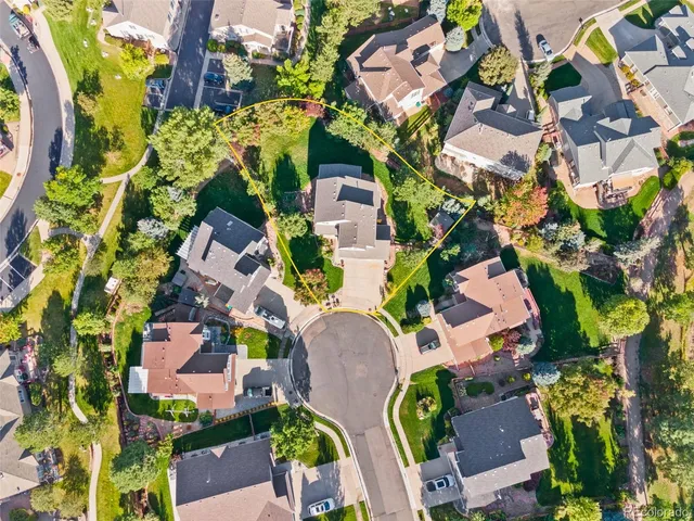 an aerial view of a residential apartment building with swimming pool and lawn chairs