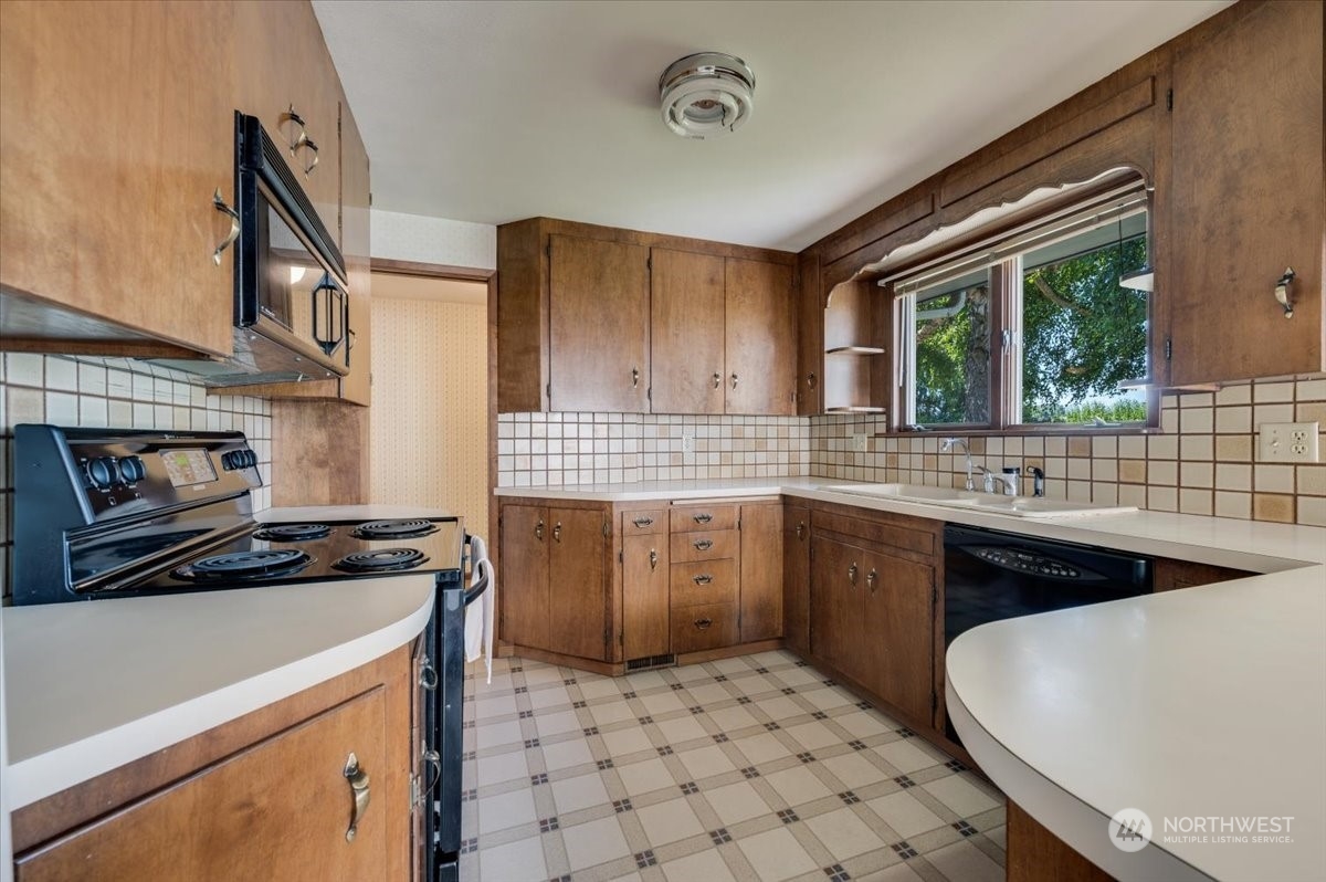 16615 Kamb Road Mount Vernon, WA 98273 - Photo 6 of 40 a kitchen with a sink stove and cabinets
