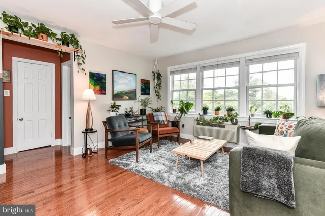 a living room with furniture and a large window