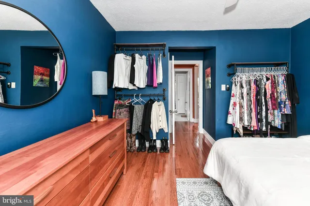 a bed room with a bed and a mirror