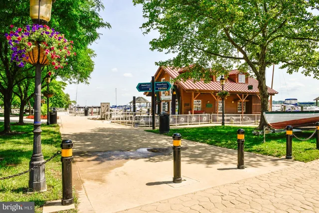a street sign on a sidewalk next to a road