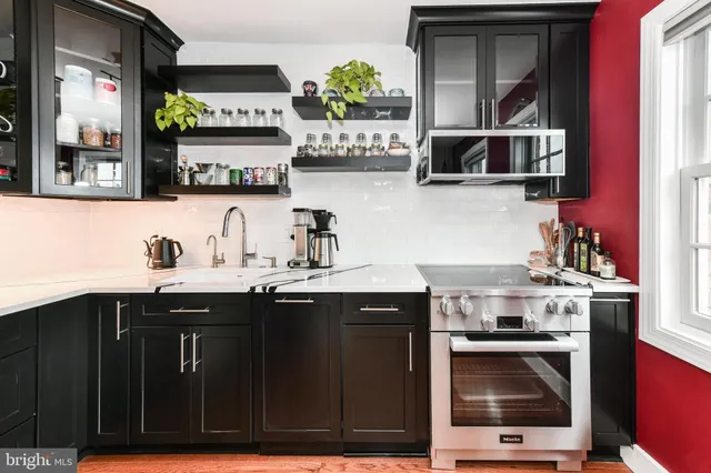 a kitchen with stainless steel appliances granite countertop a stove and a sink