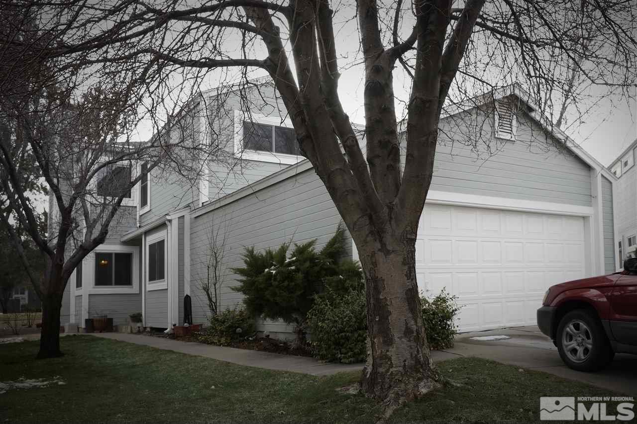 7565 Lighthouse Lane Reno, NV 89511 - Photo 1 of 1 a backyard of a house with lots of green space and fountain