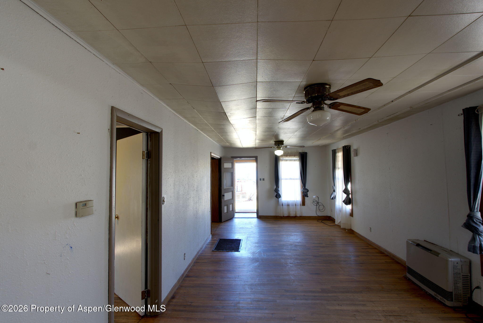 995 Colorado Street Craig, CO 81625 - Photo 11 of 21 a view of a hallway with wooden floor and staircase