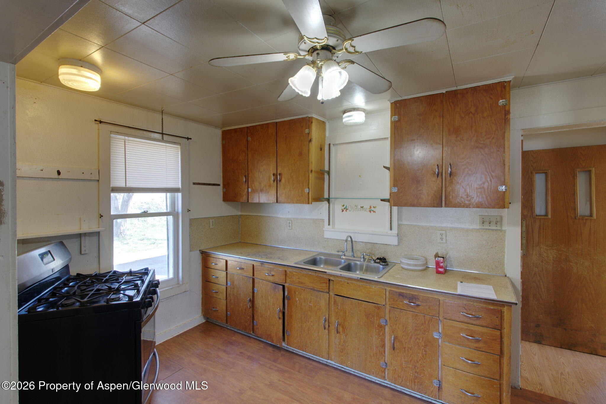 995 Colorado Street Craig, CO 81625 - Photo 12 of 21 a kitchen with a sink stove and cabinets