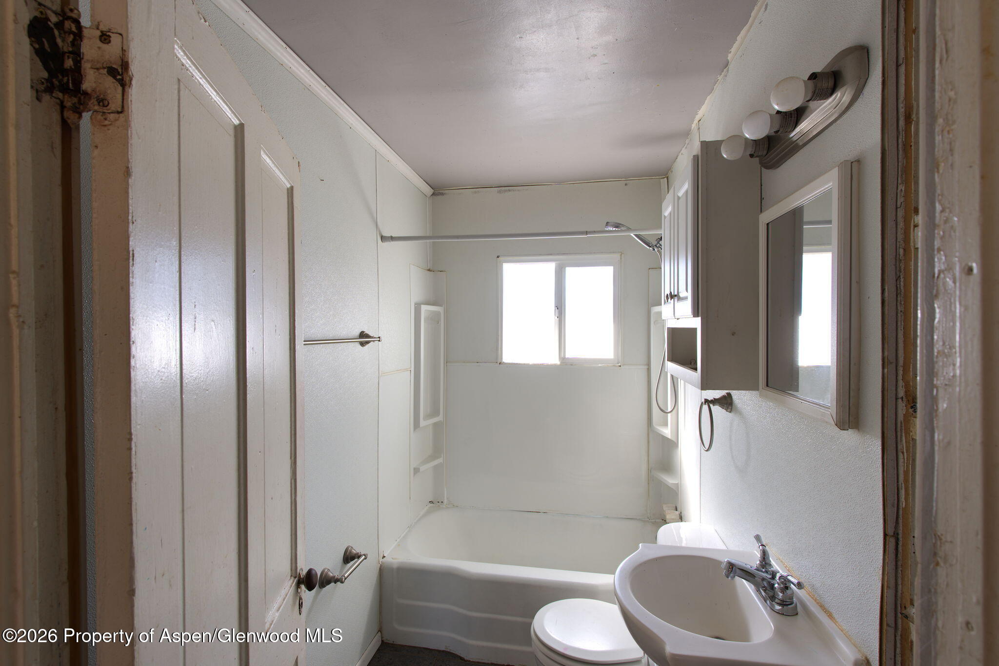 995 Colorado Street Craig, CO 81625 - Photo 14 of 21 a bathroom with a sink toilet and shower