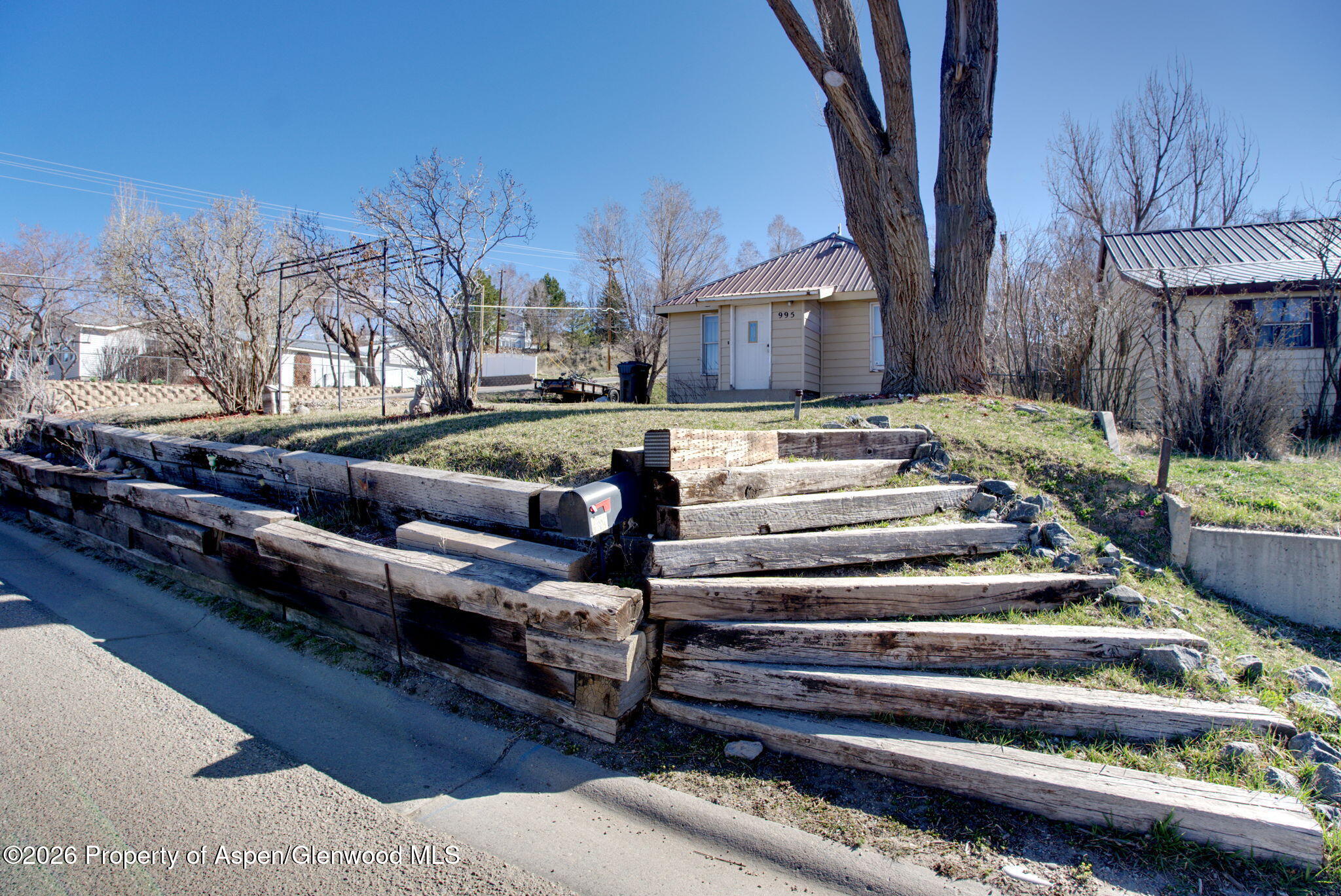 995 Colorado Street Craig, CO 81625 - Photo 2 of 21 a view of a yard with table and chairs a fire pit and a couple of flower plants