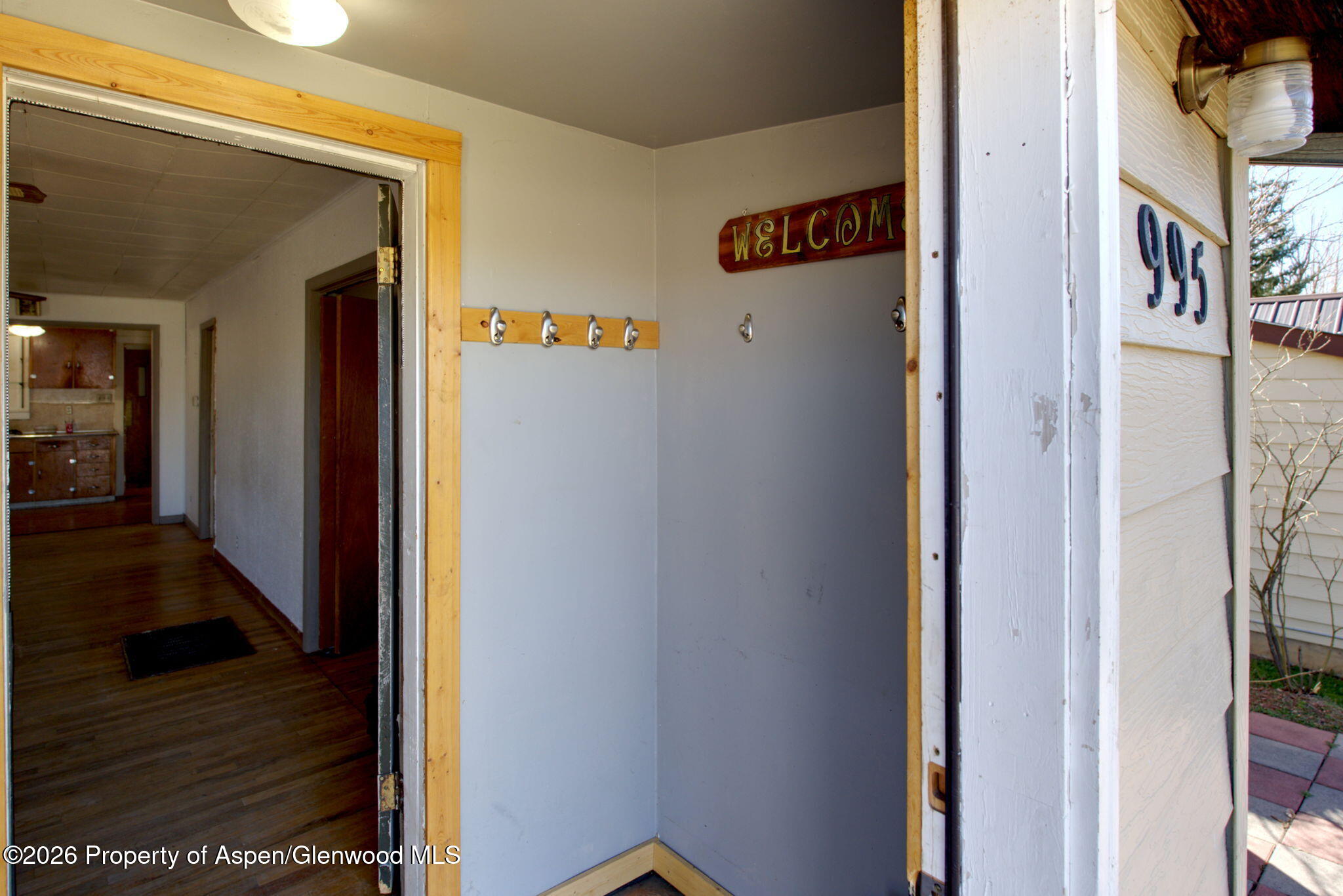995 Colorado Street Craig, CO 81625 - Photo 4 of 21 a view of a hallway with wooden floor