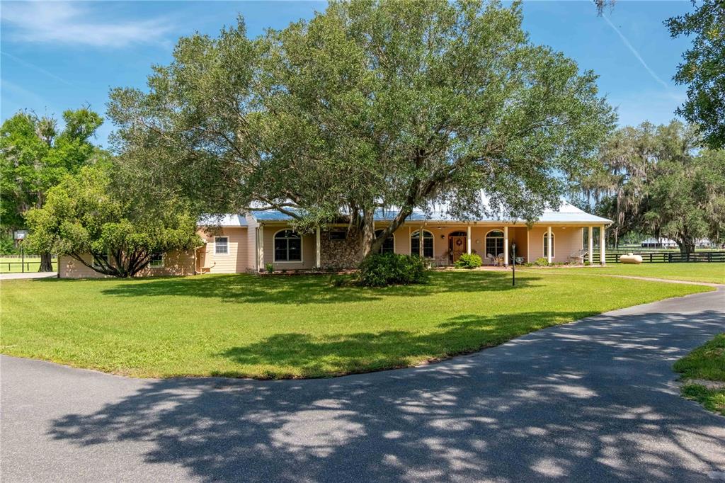 6140 Northwest 145th Avenue Road Morriston, FL 32668 - Photo 1 of 75 a front view of a house with a yard