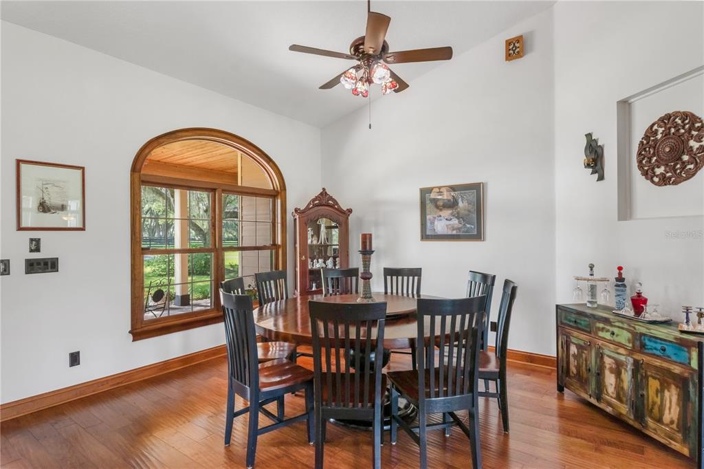 6140 Northwest 145th Avenue Road Morriston, FL 32668 - Photo 11 of 75 a view of a dining room with furniture window and wooden floor