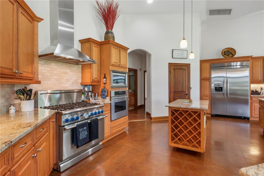 6140 Northwest 145th Avenue Road Morriston, FL 32668 - Photo 16 of 75 a kitchen with stainless steel appliances granite countertop a stove a sink and a refrigerator