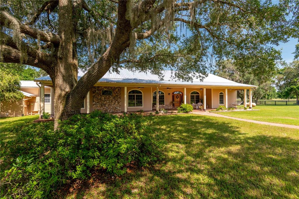 6140 Northwest 145th Avenue Road Morriston, FL 32668 - Photo 2 of 75 a front view of a house with a yard