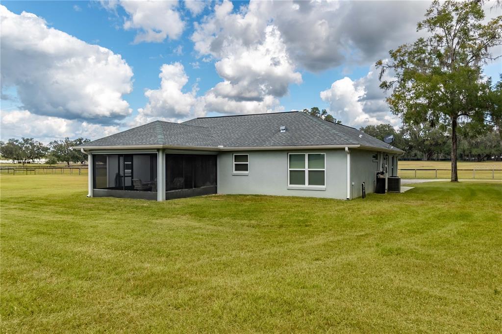 6140 Northwest 145th Avenue Road Morriston, FL 32668 - Photo 43 of 75 a view of a house with a garden and yard