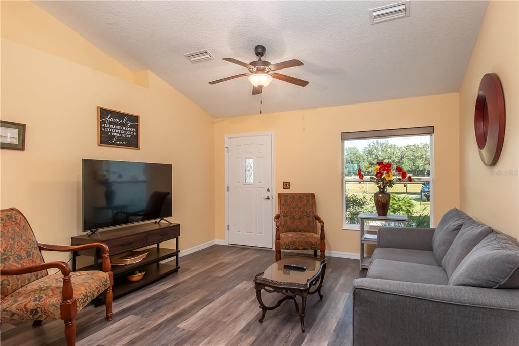 6140 Northwest 145th Avenue Road Morriston, FL 32668 - Photo 46 of 75 a living room with furniture and a flat screen tv