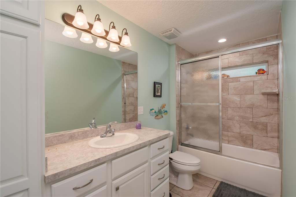 6140 Northwest 145th Avenue Road Morriston, FL 32668 - Photo 50 of 75 a bathroom with a shower sink vanity mirror and toilet