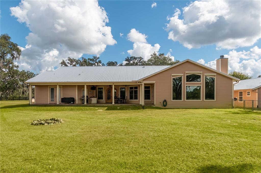 6140 Northwest 145th Avenue Road Morriston, FL 32668 - Photo 5 of 75 a front view of a house with a garden