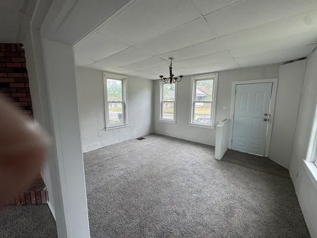 an empty room with windows and closet