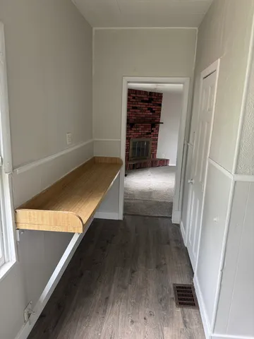a view of entryway and hall with wooden floor