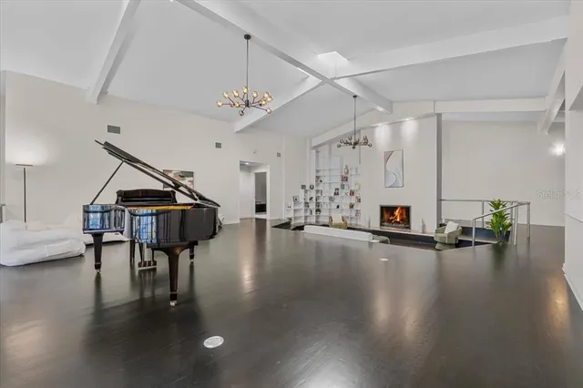 a living room with furniture stairs and a large window